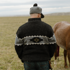 Man wearing Capriola Navajo Sweater Black Natural back view diamond pattern