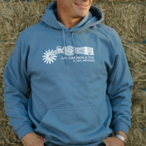Man wearing indigo blue Spur One Hoodie with Larry Bute spur artwork
