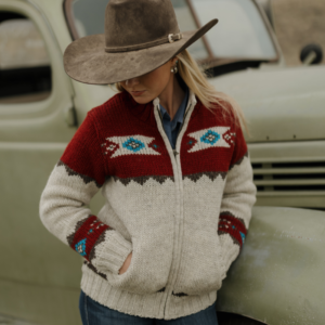 Woman wearing Ladies Navajo Sweater in ruby full zip with ruby red yoke