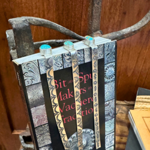 Three hand stamped sterling silver turquoise bookmarks on Bit and Spur Makers book